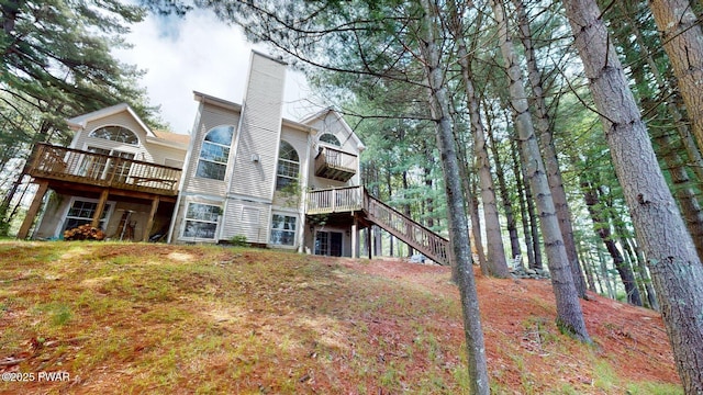 109 Lake Dr, Dingmans Ferry, PA 18328 - rear view of property featuring a deck, a chimney, and stairway