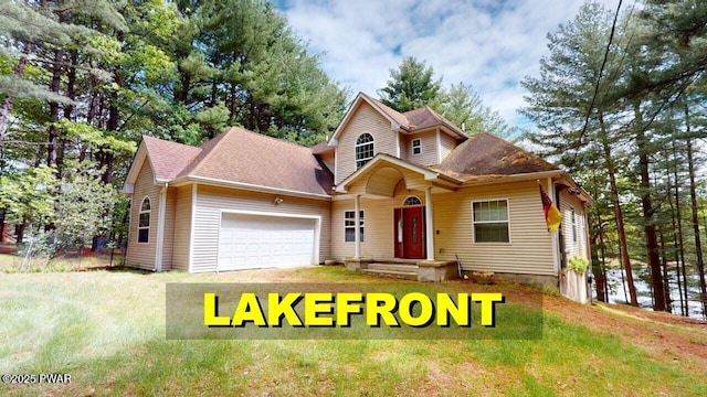 109 Lake Dr, Dingmans Ferry, PA 18328 - view of front of home with a garage, roof with shingles, and a front lawn