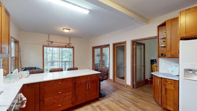 109 Lake Dr, Dingmans Ferry, PA 18328 - kitchen with french doors, white refrigerator with ice dispenser, light wood-style floors, light countertops, and a peninsula