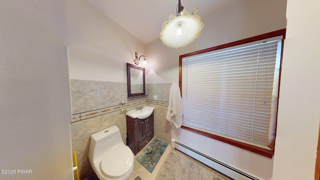 109 Lake Dr, Dingmans Ferry, PA 18328 - half bath featuring a baseboard heating unit, tile walls, vanity, and wainscoting
