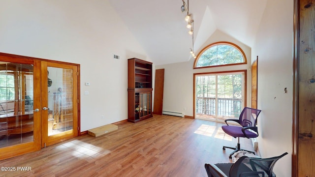 109 Lake Dr, Dingmans Ferry, PA 18328 - living area featuring french doors, healthy amount of natural light, high vaulted ceiling, and light wood-style flooring