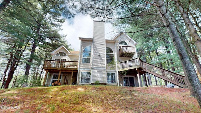 109 Lake Dr, Dingmans Ferry, PA 18328 - rear view of property with a chimney, stairs, and a wooden deck