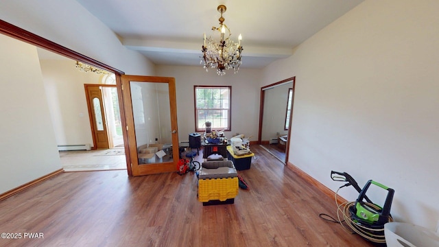 109 Lake Dr, Dingmans Ferry, PA 18328 - foyer with wood finished floors, a chandelier, beam ceiling, french doors, and a baseboard radiator
