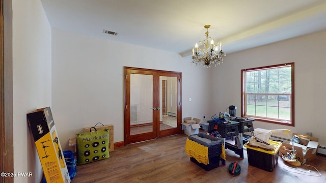 109 Lake Dr, Dingmans Ferry, PA 18328 - dining room with french doors, wood finished floors, a chandelier, and a baseboard radiator