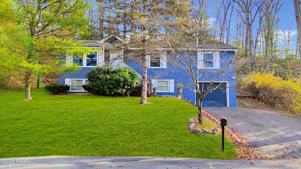 view of front facade with a front lawn and a garage