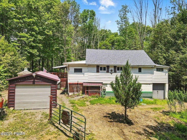 36 Rolling Acres Rd, Lake Ariel, PA 18436 - view of front facade with an outbuilding, roof with shingles, and a forest view