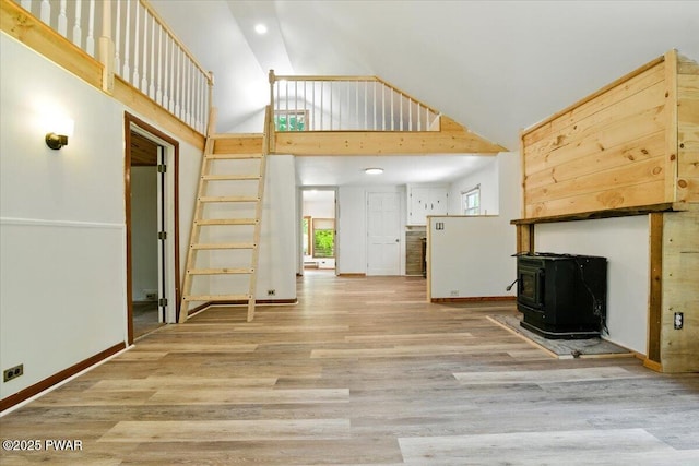 36 Rolling Acres Rd, Lake Ariel, PA 18436 - unfurnished living room with a wood stove, high vaulted ceiling, wood finished floors, and recessed lighting