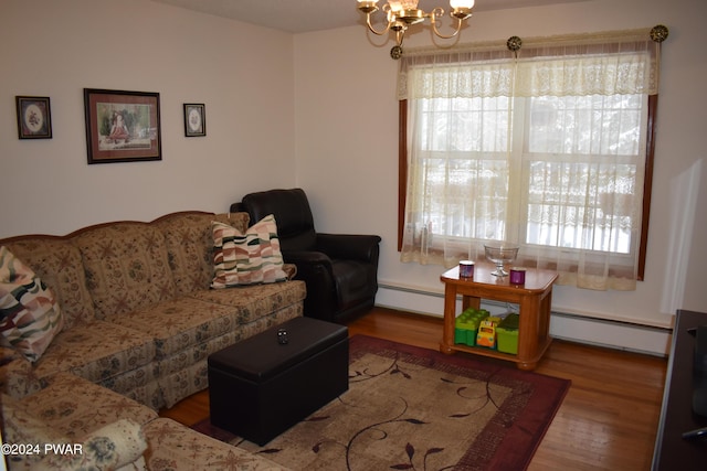 living room featuring baseboard heating, a chandelier, and light hardwood / wood-style floors