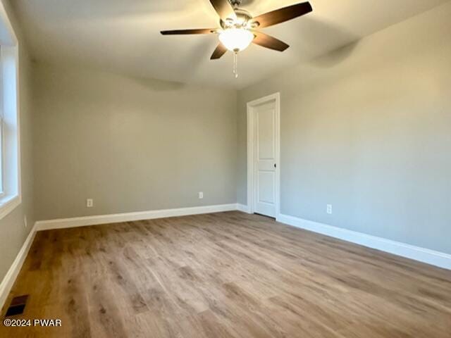 spare room featuring ceiling fan and light hardwood / wood-style flooring