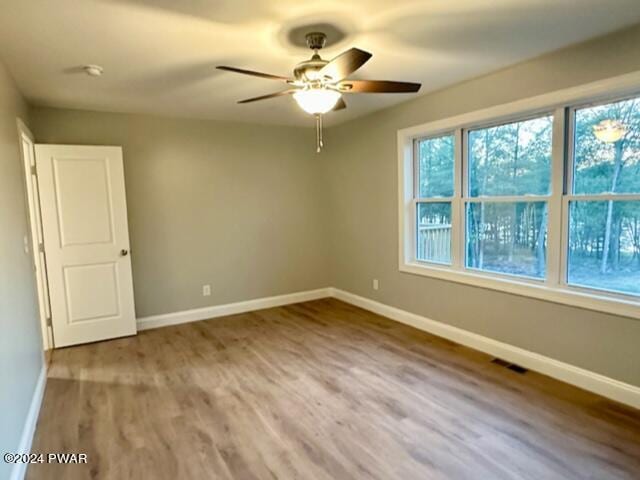 unfurnished room featuring wood-type flooring and ceiling fan