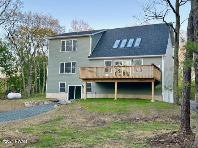 rear view of house featuring a deck