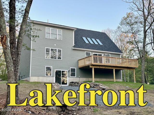 rear view of house featuring a deck