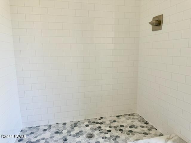 bathroom with a tile shower