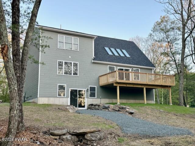 rear view of property with a wooden deck