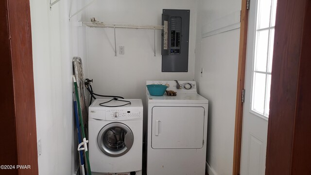 laundry room featuring washing machine and clothes dryer and electric panel