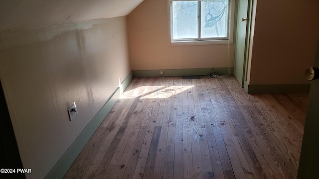 bonus room with lofted ceiling and light hardwood / wood-style flooring