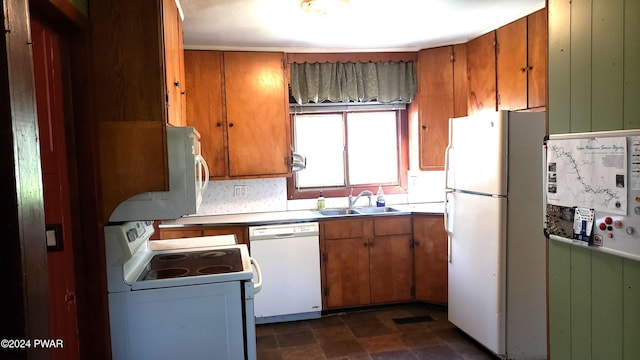 kitchen featuring white appliances and sink