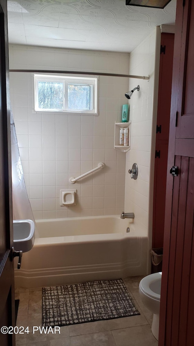 bathroom with toilet, tile patterned floors, and shower / tub combo with curtain