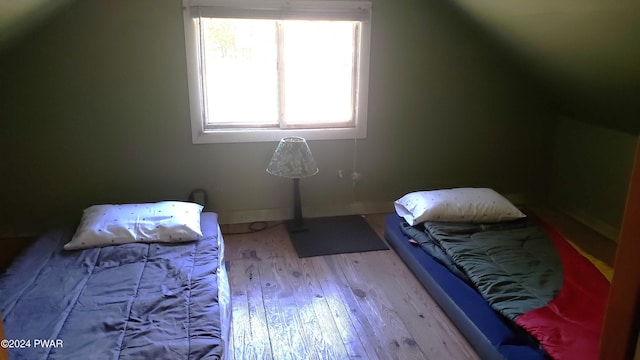 bonus room featuring a wealth of natural light, light hardwood / wood-style flooring, and lofted ceiling