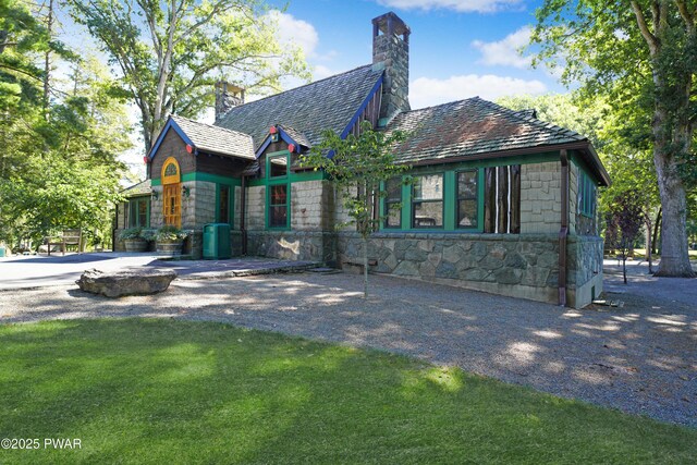 111 Blueridge Ln, Lords Valley, PA 18428 - view of front facade featuring a chimney, a front yard, and stone siding