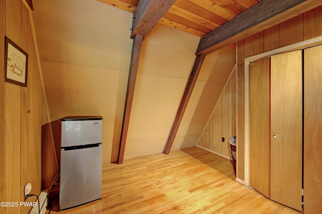 111 Blueridge Ln, Lords Valley, PA 18428 - basement with freestanding refrigerator, wood finished floors, and a baseboard radiator