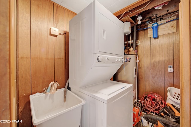111 Blueridge Ln, Lords Valley, PA 18428 - laundry area with estacked washer and dryer, water heater, and wooden walls