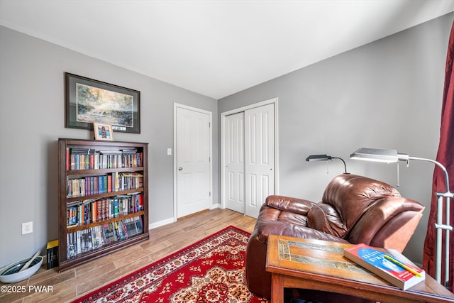 sitting room with wood finished floors and baseboards