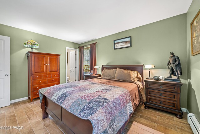 414 Leisure Loop, Milford, PA 18337 - bedroom featuring baseboard heating, wood tiled floors, and baseboards