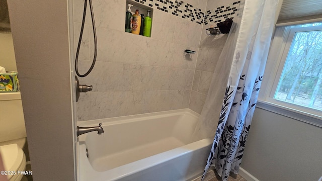 full bathroom featuring shower / bath combo, baseboards, and toilet
