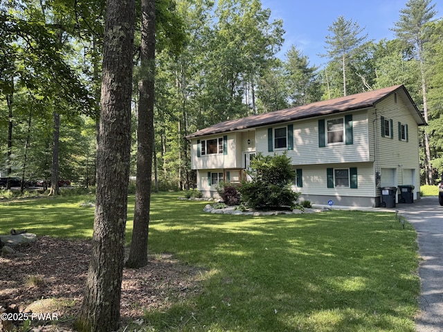 414 Leisure Loop, Milford, PA 18337 - raised ranch with asphalt driveway, a garage, and a front lawn