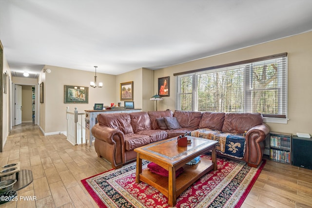 living room with light wood-type flooring and a chandelier