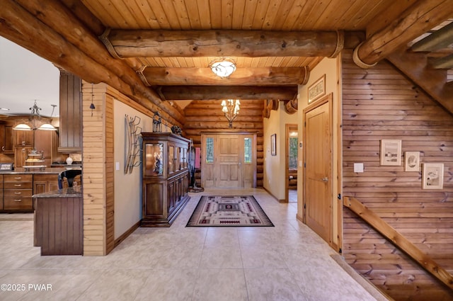 entrance foyer with beamed ceiling, rustic walls, wooden ceiling, and light tile patterned floors