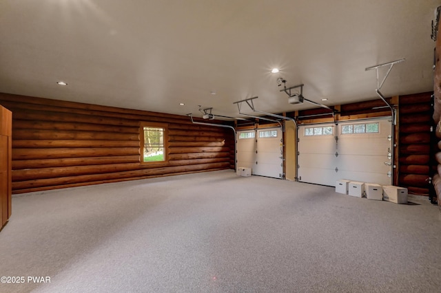 garage with recessed lighting and a garage door opener
