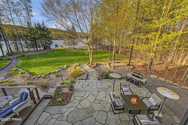 view of patio featuring a water view and an outdoor fire pit