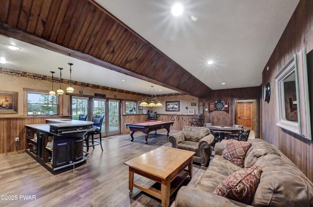 living area featuring wooden walls, pool table, and wood finished floors