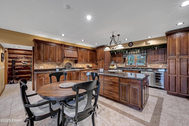 kitchen with stainless steel dishwasher, wine cooler, a kitchen island, recessed lighting, and backsplash