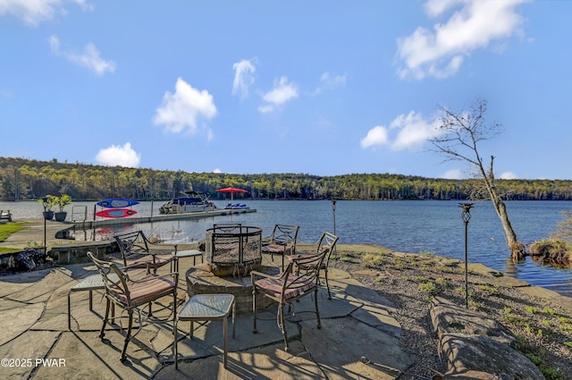 exterior space with a water view and a wooded view