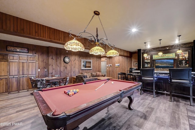 game room with wooden walls, pool table, and wood finished floors