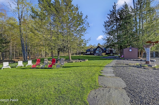 view of yard featuring a storage shed and an outbuilding