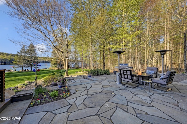 view of patio / terrace featuring a water view and an outdoor fire pit