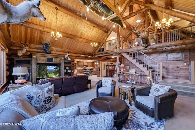 living room featuring stairs, a notable chandelier, wooden ceiling, and carpet