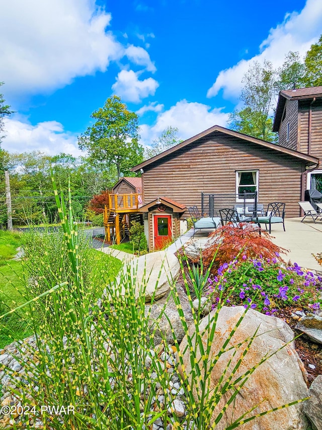 back of house with a patio area and a wooden deck