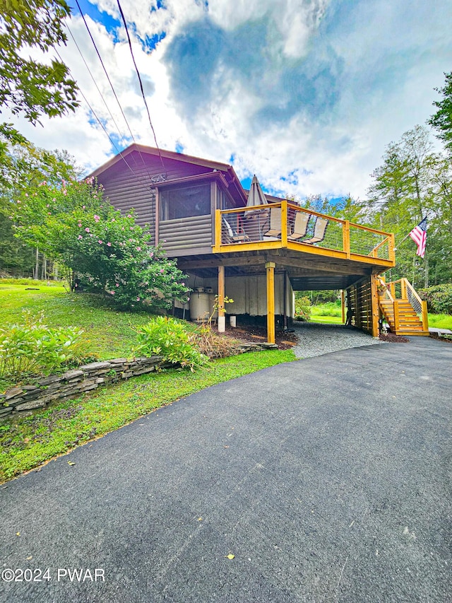 view of side of property featuring a yard and a wooden deck