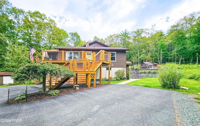 view of front facade with a front yard and a wooden deck