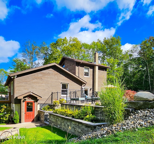 rear view of house featuring a deck