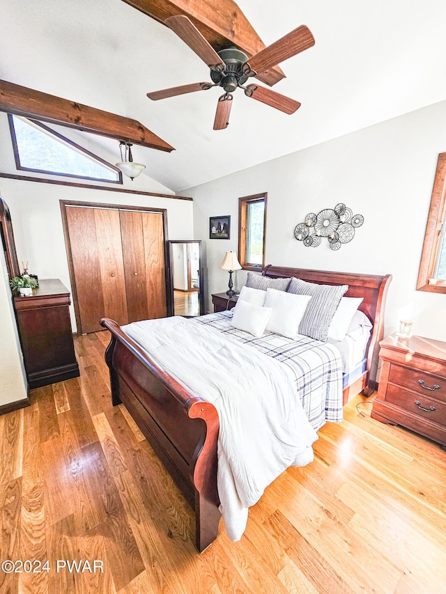 bedroom with ceiling fan, lofted ceiling with beams, and hardwood / wood-style flooring