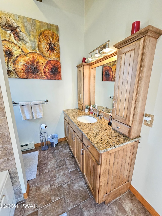 bathroom with baseboard heating and vanity