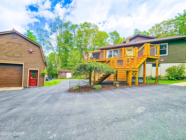 view of front facade with a garage and a wooden deck