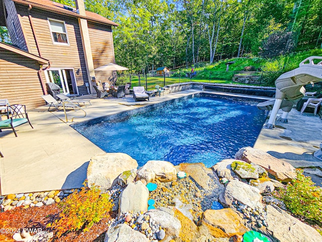 view of swimming pool with a patio area