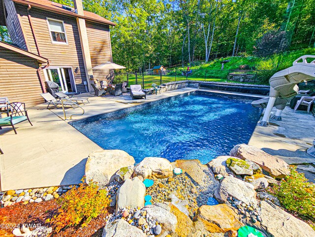 view of swimming pool with a patio area